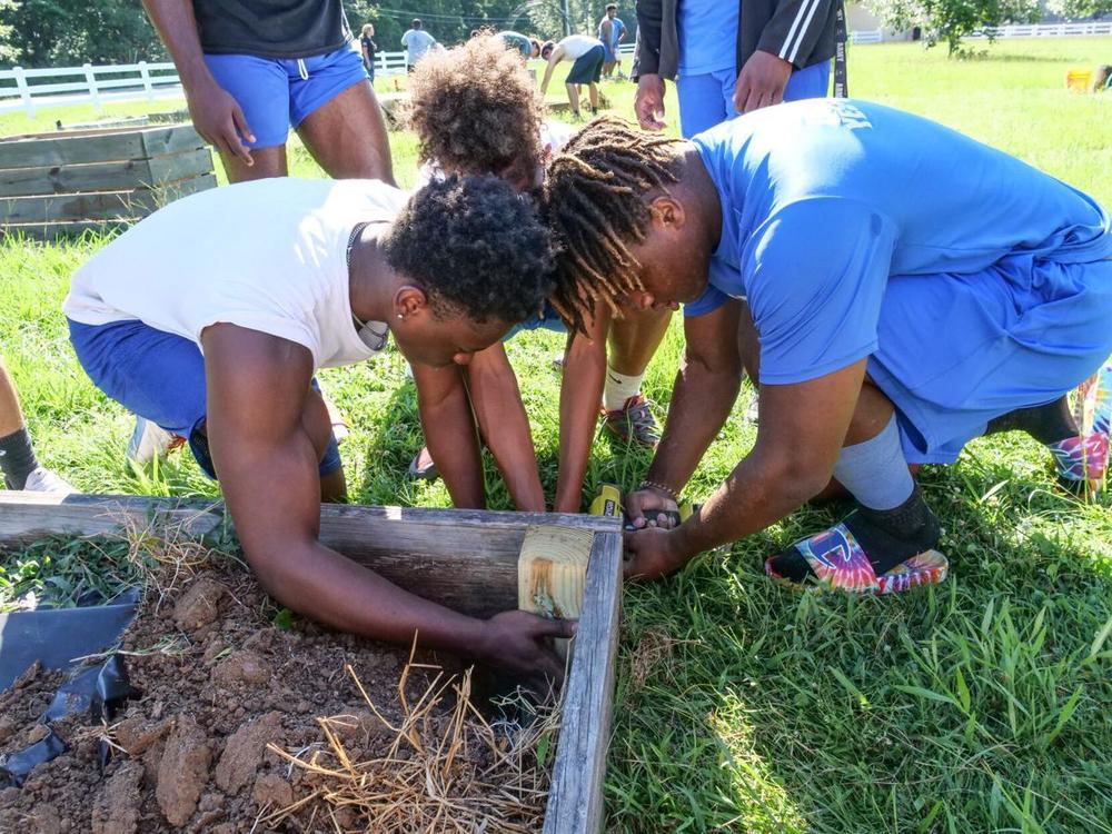 West Feliciana High football players put down football, pick up rake to clean up Bains garden