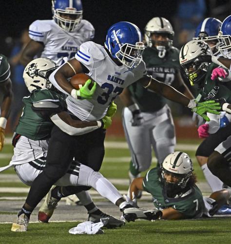 West Feliciana's Ja'Terrius Johnson (37) carries the ball before the stop by Plaquemine's Shermar Carter (3), Friday, November 4, 2022 at Plaquemine High School. 