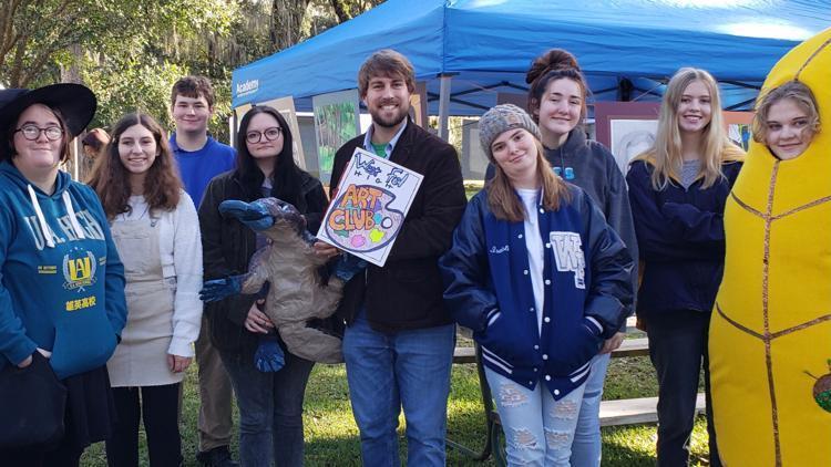 West Feliciana High School Art Club members showcase student work during Yellow Leaf festivities. In attendance are Hannah Shore, Molly Johnson, Edward Garig, Maggie Cloughley, Lane Thompson, Isabelle Montandon, Anna Landry, Brooklyn Phelan and Millie Lou Wilson.