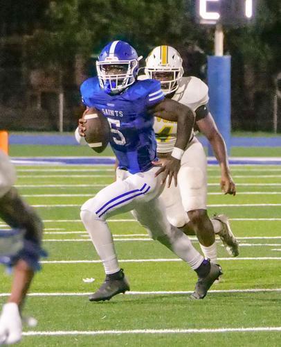 West Feliciana quarterback Joel Rogers (5) tries to find a receiver on Friday night in St Francisville. 