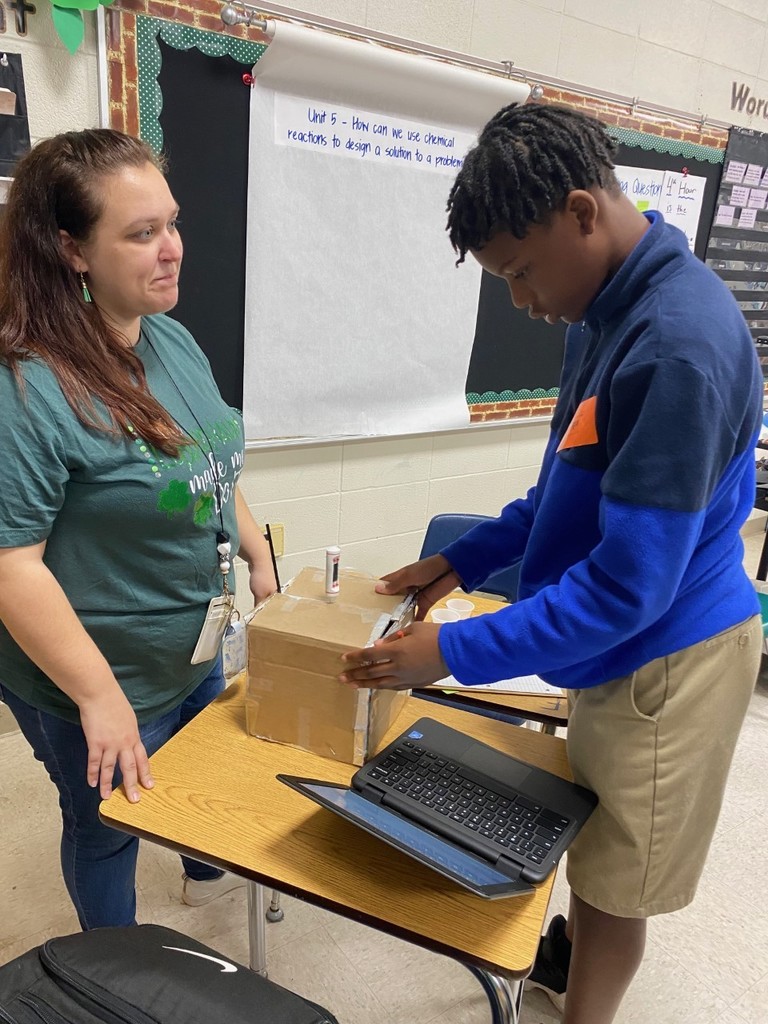 Student shows experiment to teacher for evaluation.