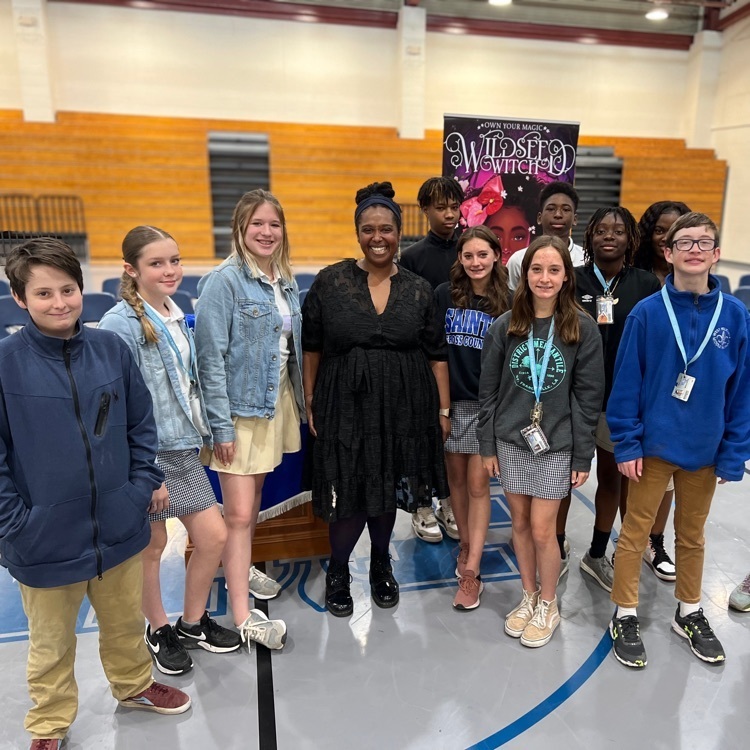 Students take a photo with guest author  