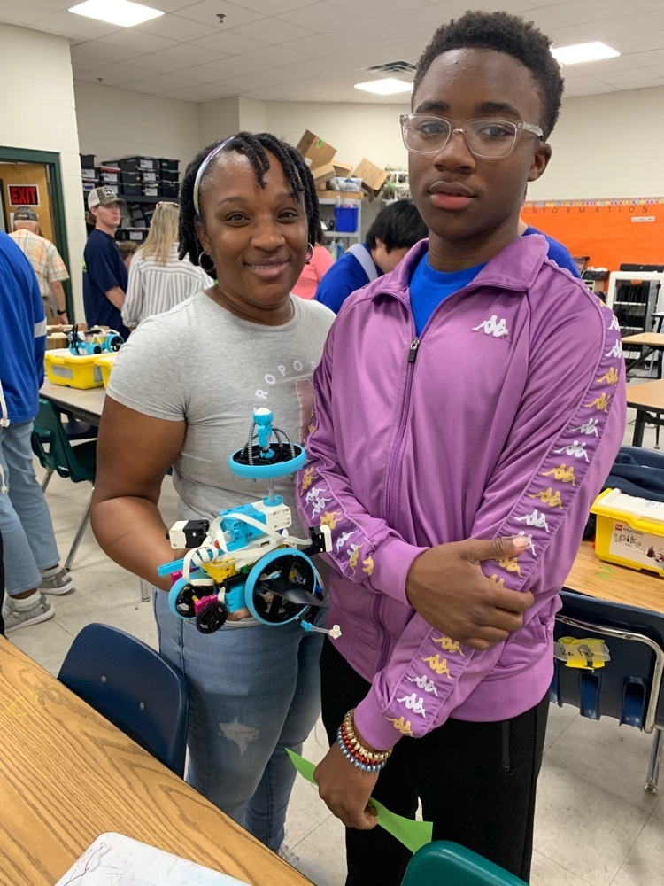 Student shows his mom his robot. m